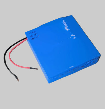 Blue battery pack with cables on a wooden floor