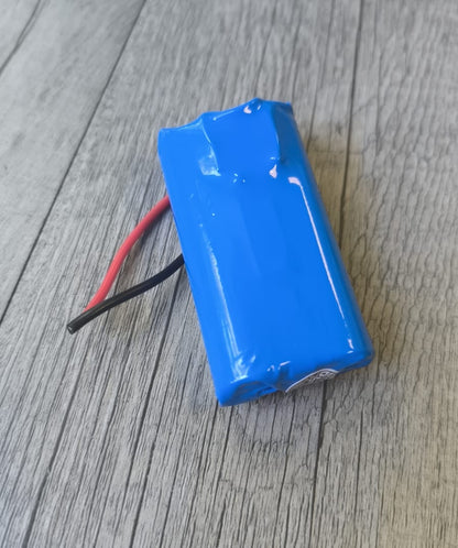Blue battery pack on a wooden surface