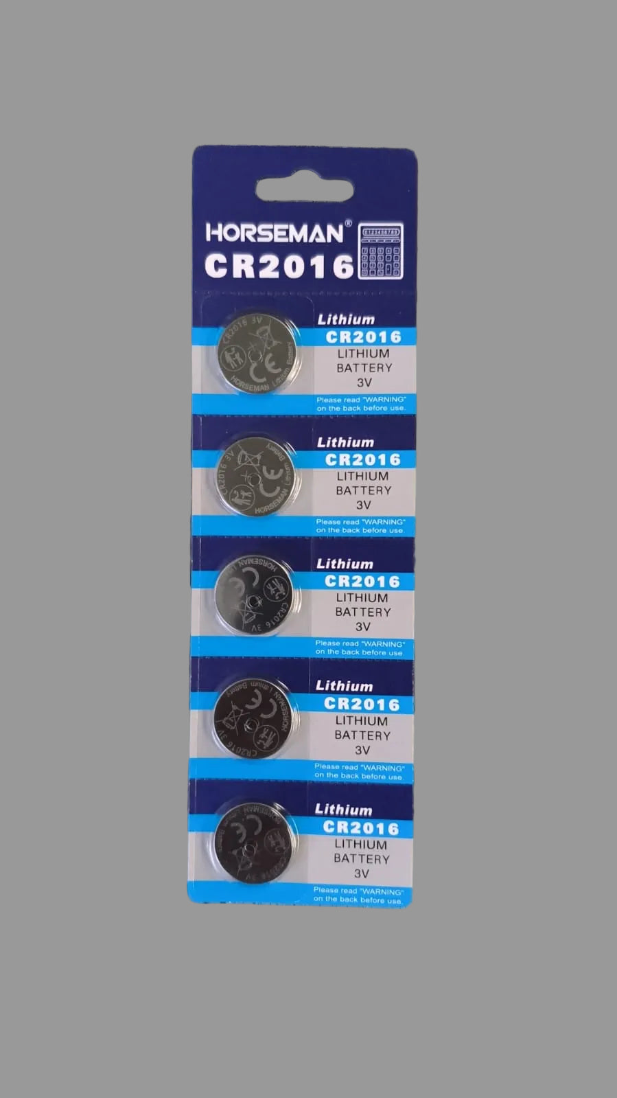 Pack of Horseman CR2016 lithium batteries on a wooden surface